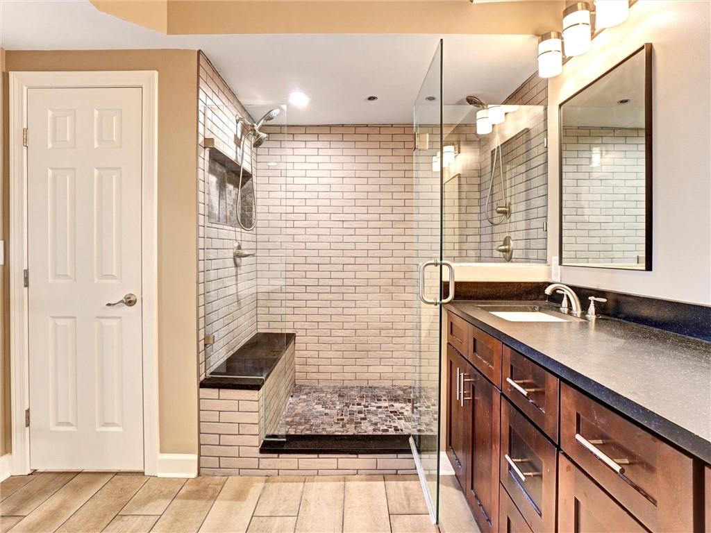 3435 Kingsboro Road Northeast, Unit 1601 Atlanta, GA 30326 - Photo 18 of 54 a bathroom with a sink shower and a mirror