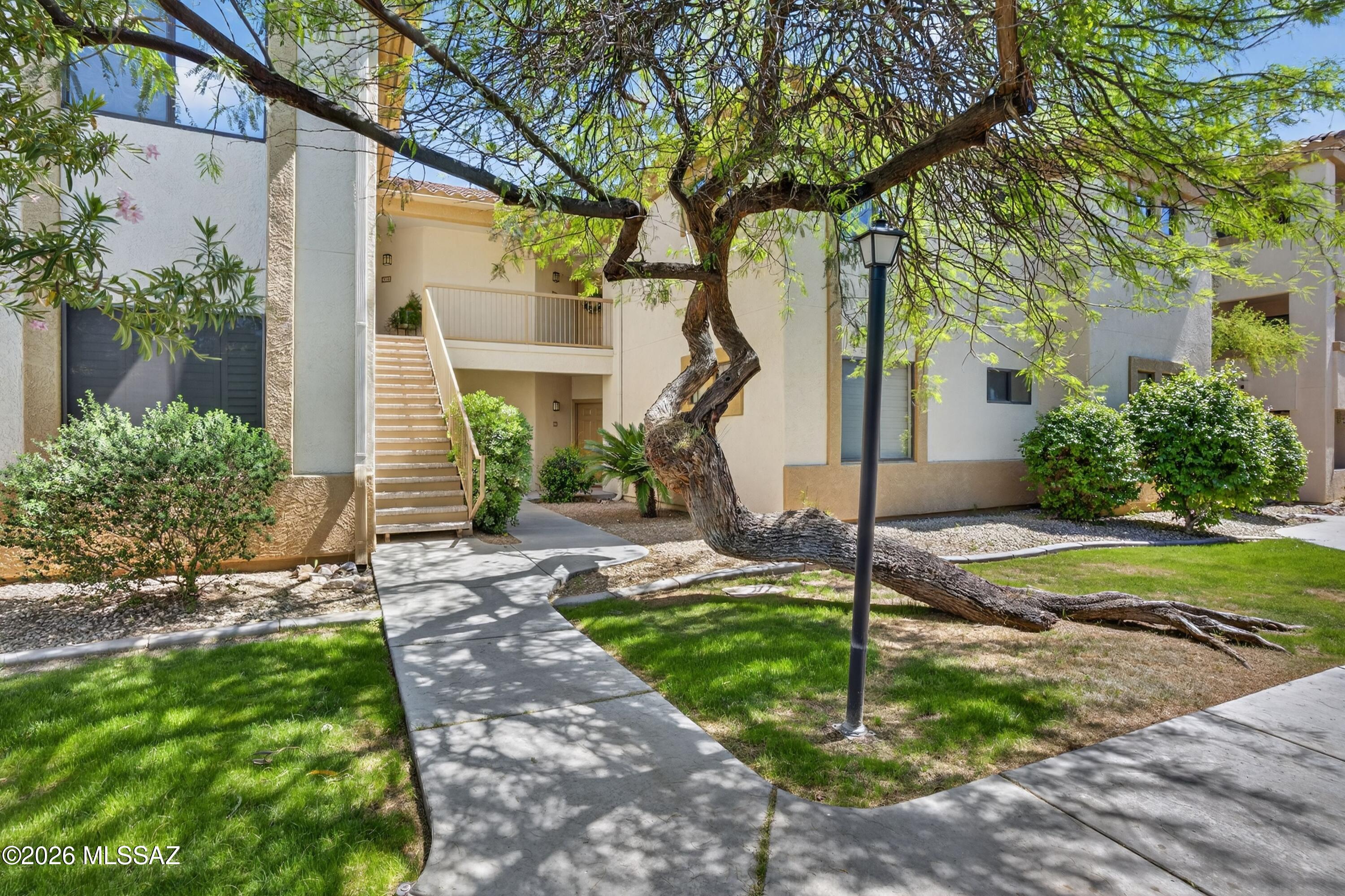2550 East River Road, Unit 4204 Tucson, AZ 85718 - Photo 1 of 36 a front view of a house with garden