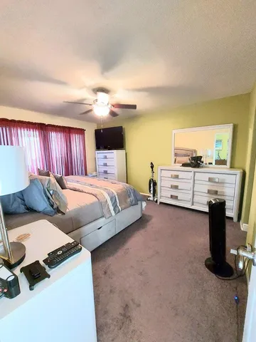 a bedroom with bed and window