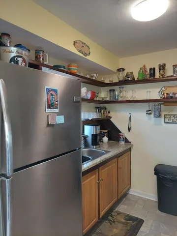 a kitchen with stainless steel appliances granite countertop a sink and a white cabinets