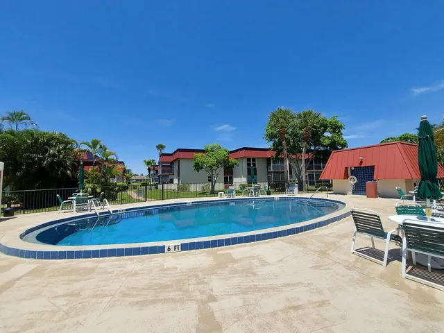 a view of swimming pool with outdoor seating and plants