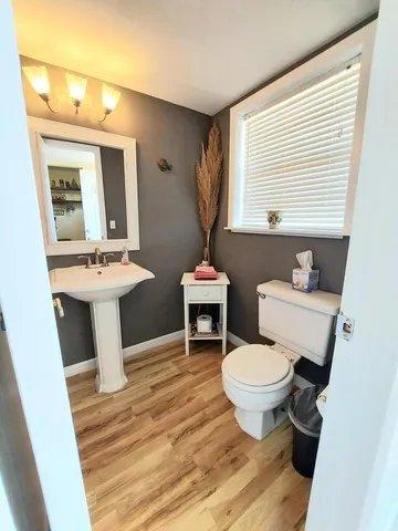 a bathroom with a toilet sink and mirror