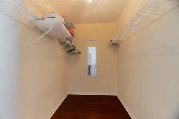a bathroom with a toilet a sink a mirror a shower a vanity and window