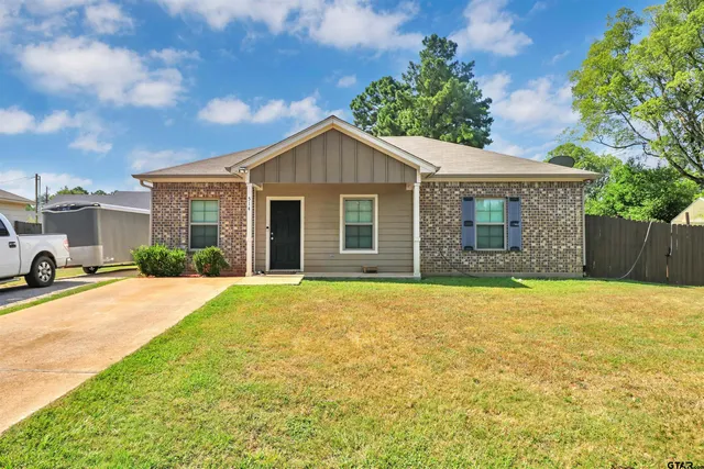 a view of a house with a yard and garage
