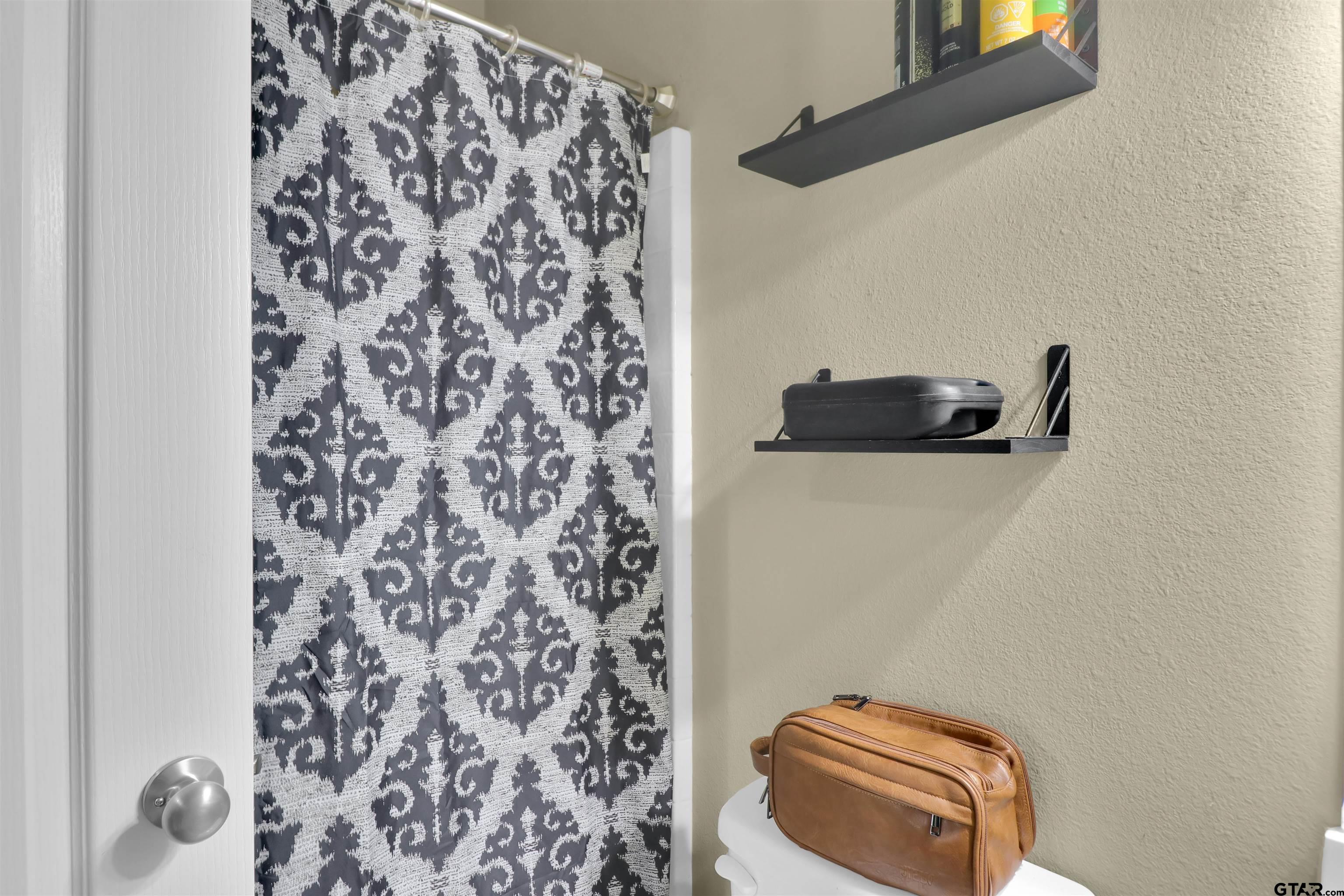 514 County Road 1201 Rusk, TX 75785 - Photo 20 of 29 a bathroom with a toilet and a shower curtain