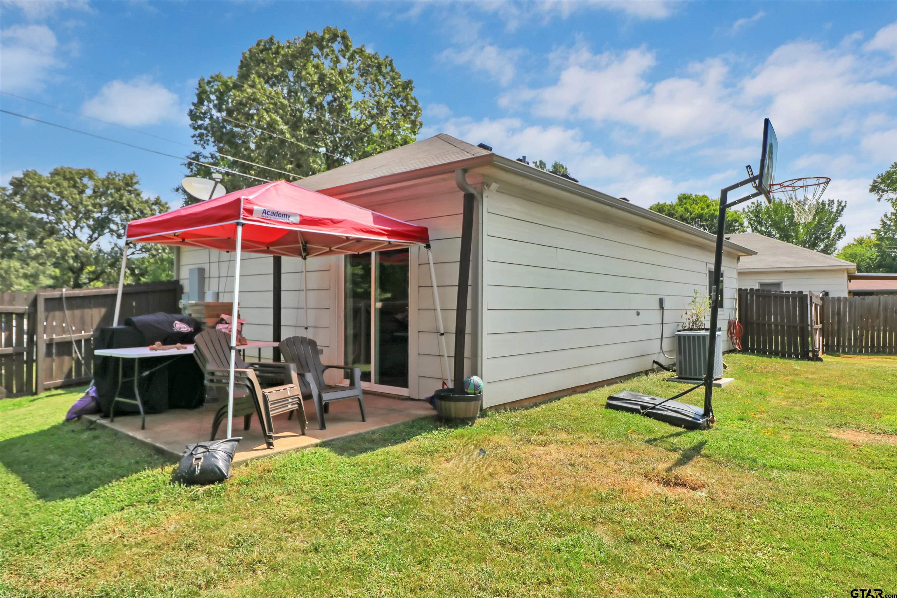 514 County Road 1201 Rusk, TX 75785 - Photo 25 of 29 a view of a patio with a table and chairs under an umbrella