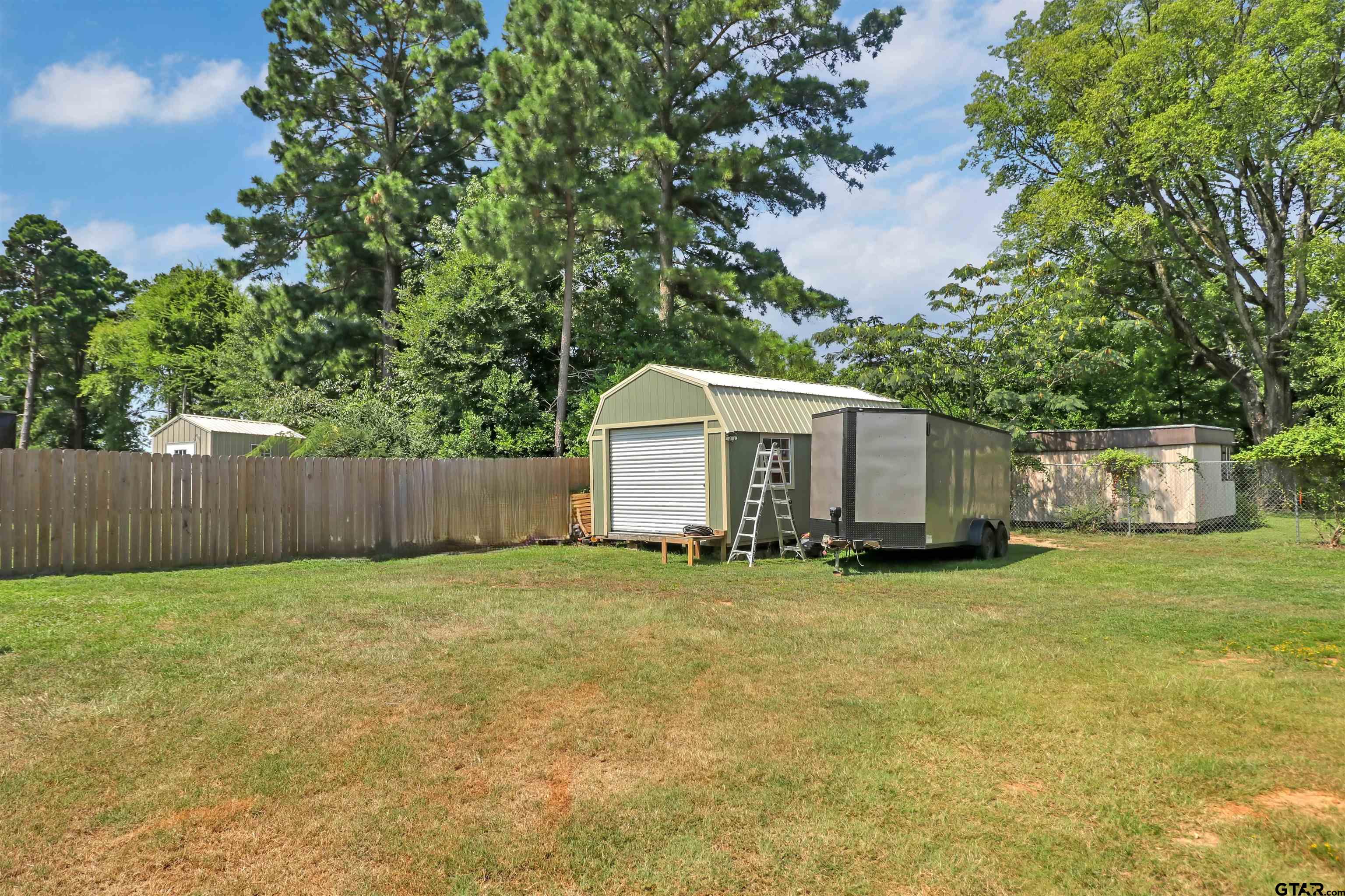 514 County Road 1201 Rusk, TX 75785 - Photo 27 of 29 a front view of a house with a garden and trees