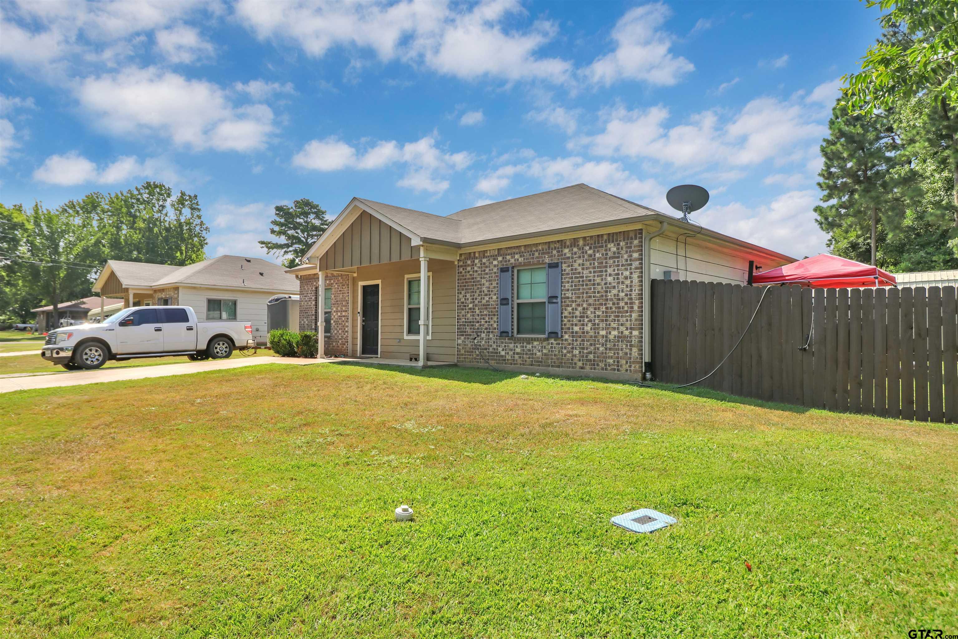514 County Road 1201 Rusk, TX 75785 - Photo 3 of 29 a front view of a house with a garden