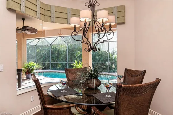 a view of a dining room with furniture wooden floor and a potted plant