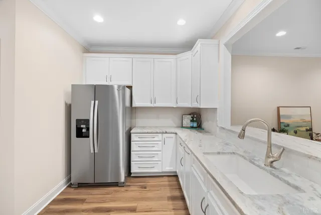 a kitchen with granite countertop a sink and steel appliances