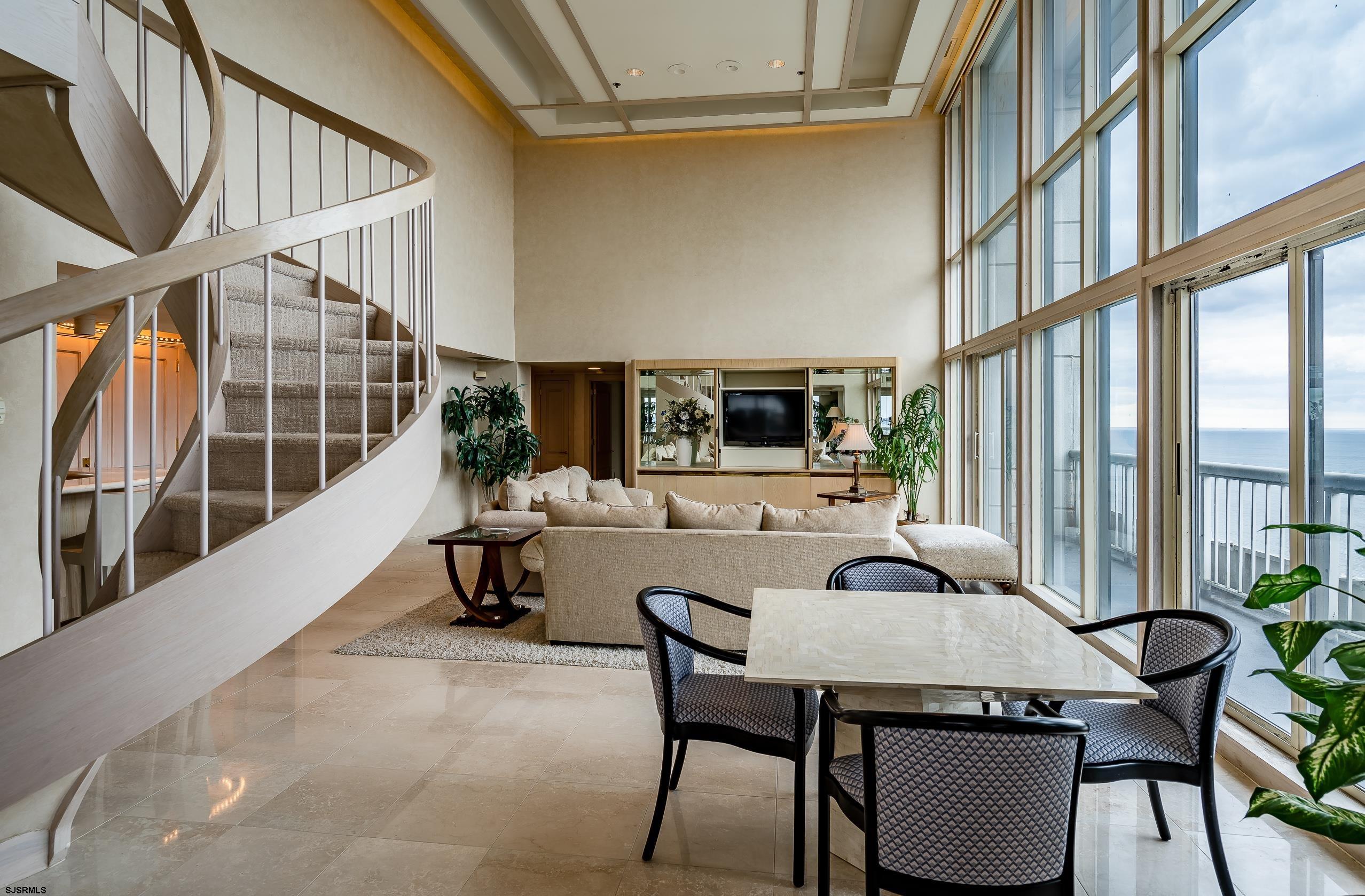3101 Boardwalk, Unit CONDO Atlantic City, NJ 08401 - Photo 11 of 46 a dining room with furniture and a floor to ceiling window