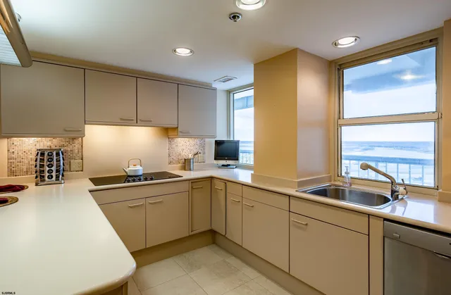 a kitchen with sink and cabinets