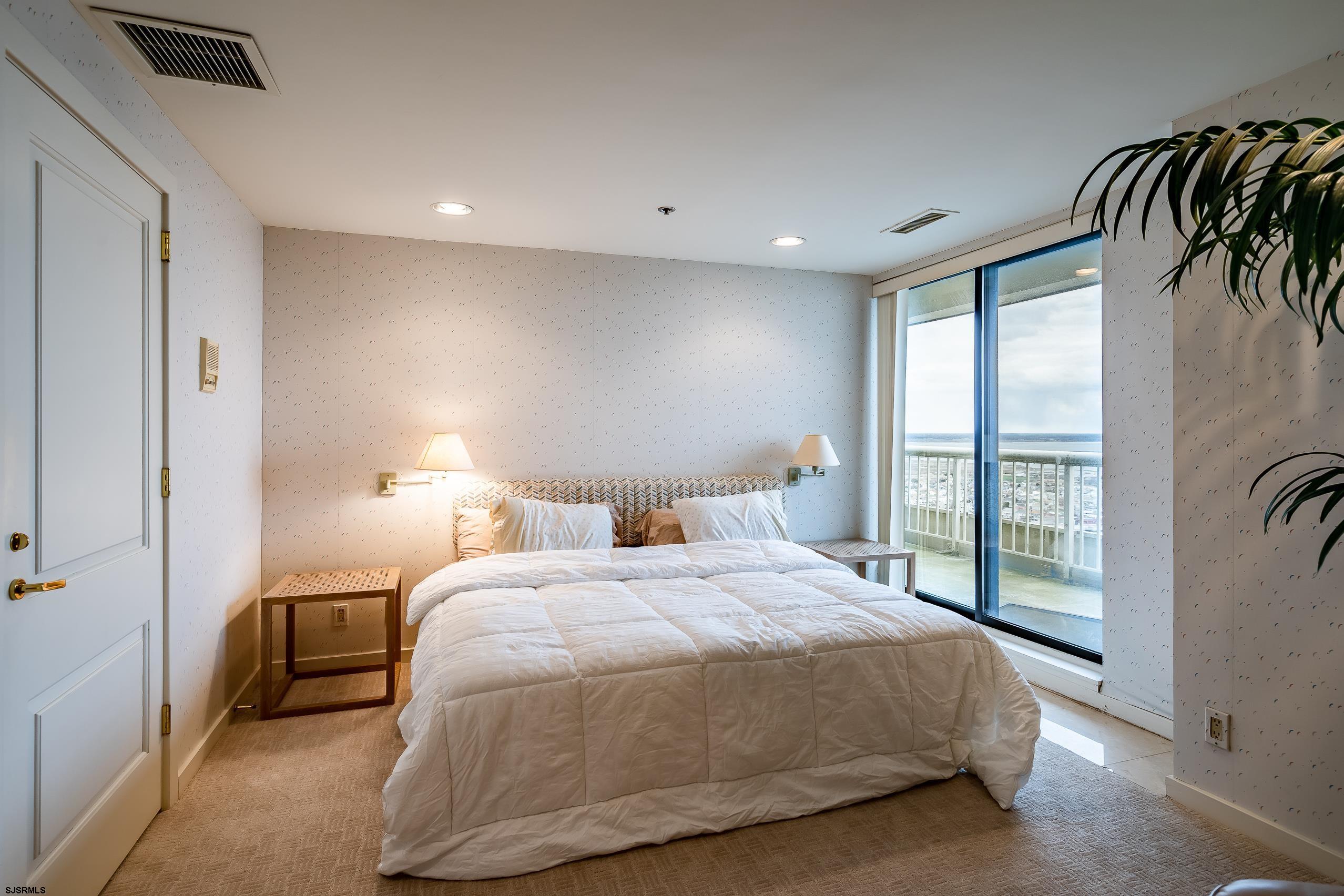 3101 Boardwalk, Unit CONDO Atlantic City, NJ 08401 - Photo 18 of 46 a spacious bedroom with a bed and a large window