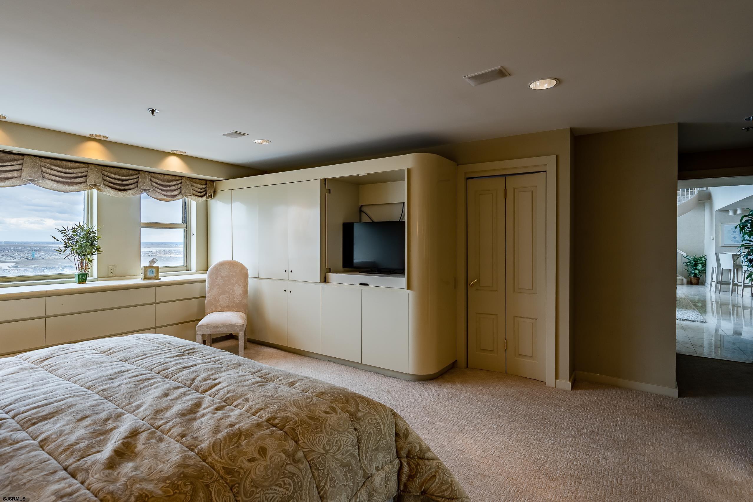 3101 Boardwalk, Unit CONDO Atlantic City, NJ 08401 - Photo 27 of 46 a bedroom with a bed and large windows