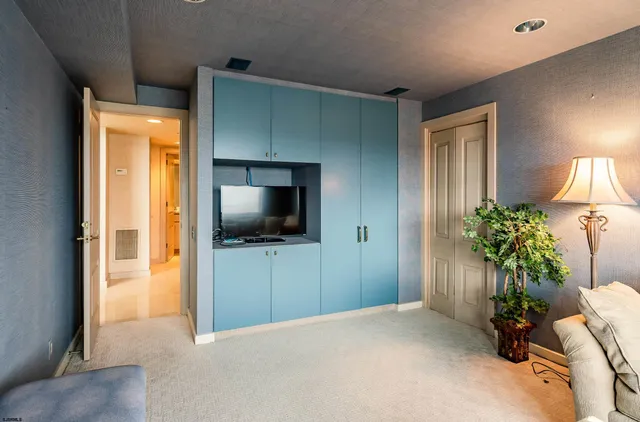 a bedroom with furniture and a potted plant