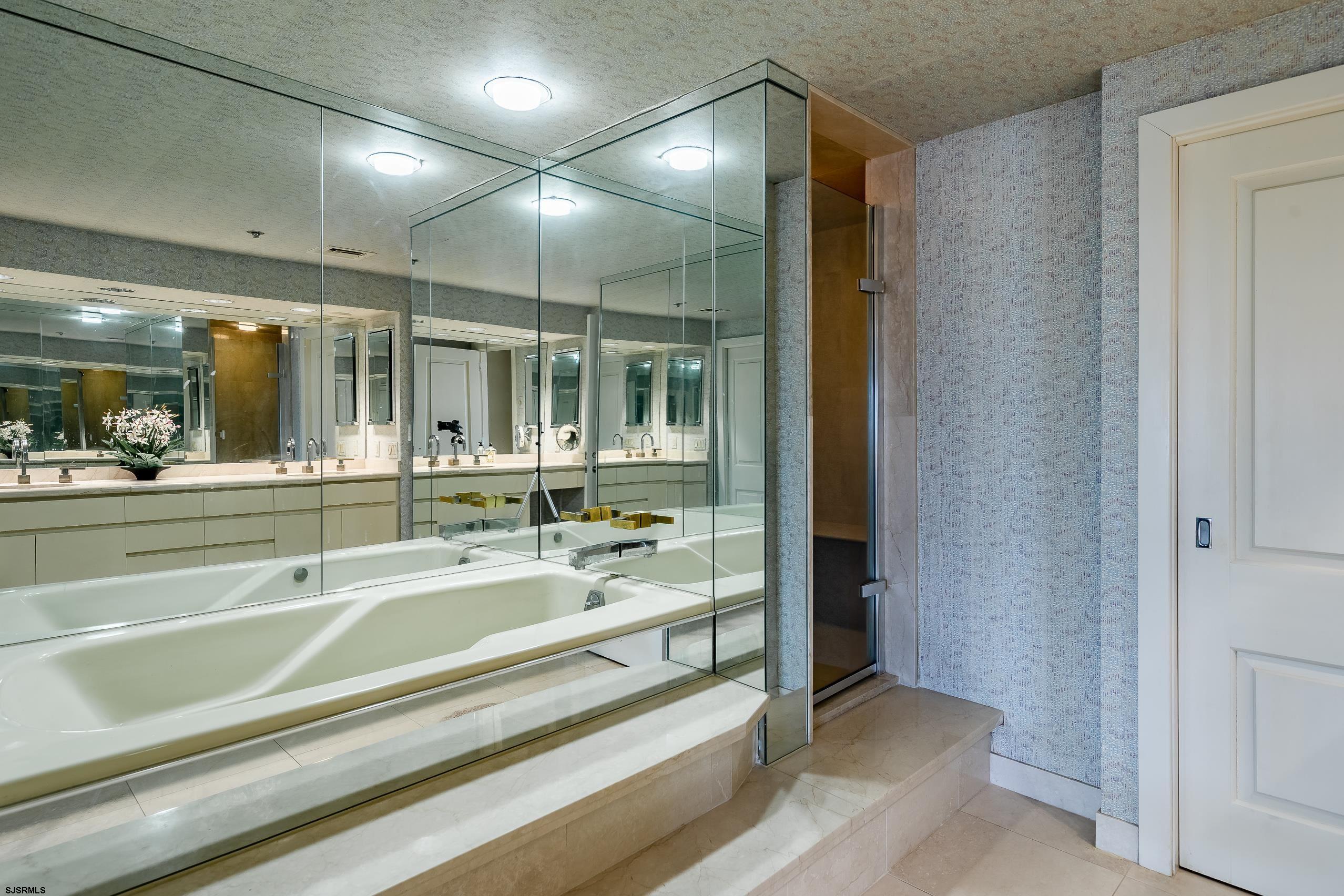 3101 Boardwalk, Unit CONDO Atlantic City, NJ 08401 - Photo 32 of 46 a spacious bathroom with a mirror and shower