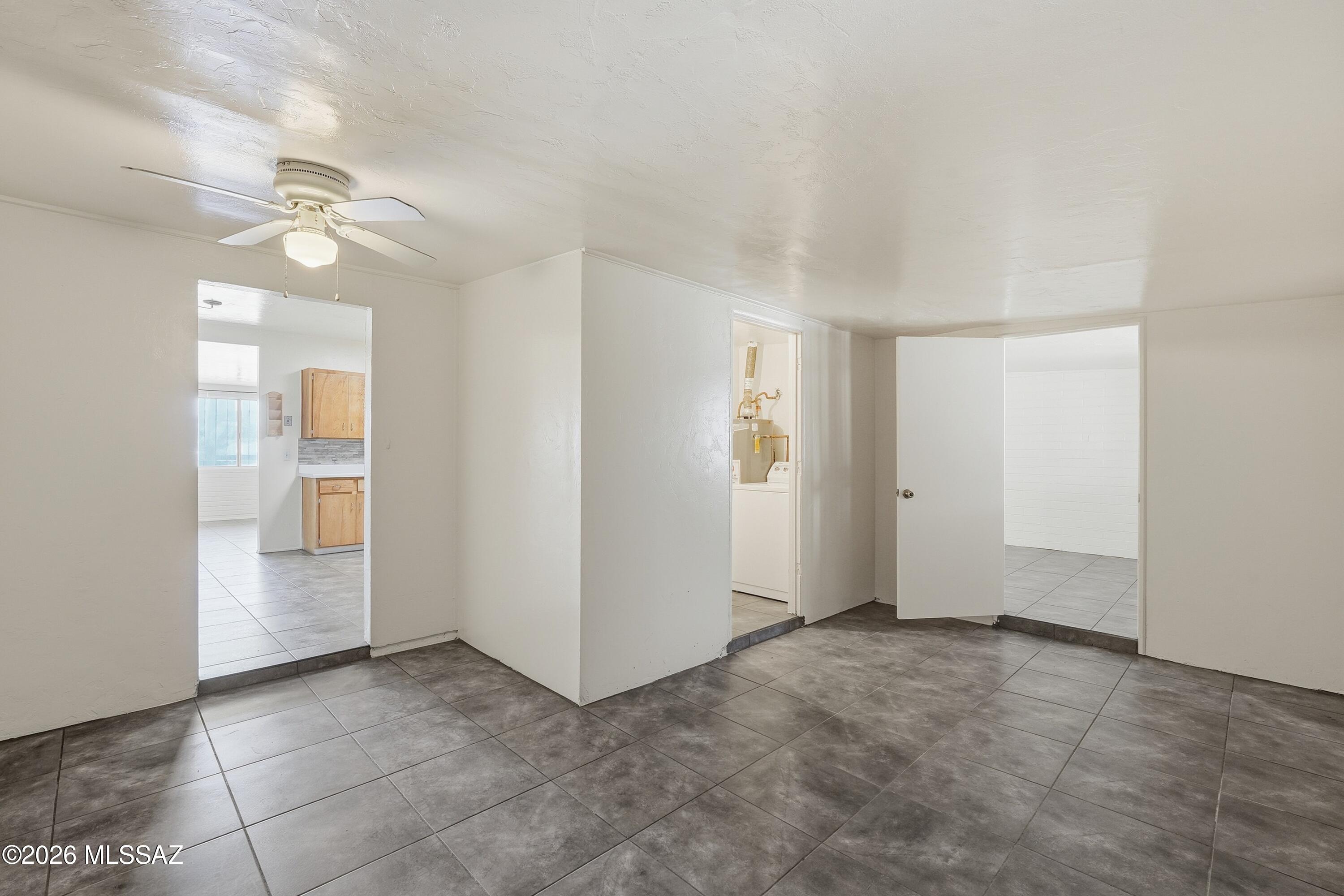 1808 West Caravelle Road Tucson, AZ 85713 - Photo 8 of 38 an empty room with closet and a ceiling fan