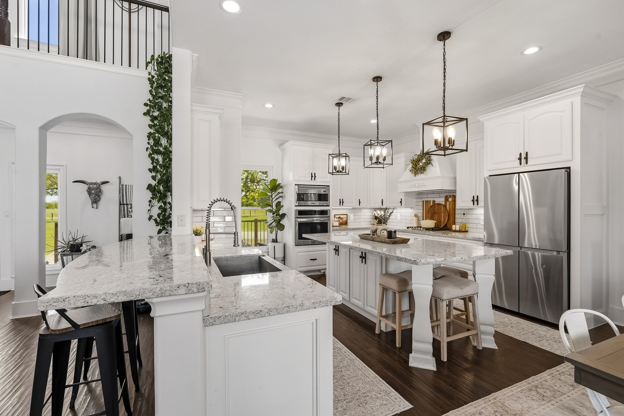 3103 Brundrett Road Wallis, TX 77485 - Photo 13 of 45 The heart of the home, this stunning designer Kitchen combines timeless finishes with inviting farmhouse charm. Granite countertops, a crisp white subway tile backsplash, bright white cabinetry, and stylish hardware create a fresh and welcoming aesthetic. Spacious, functional, and effortlessly elegant, this Kitchen is designed to bring family and friends together for years to come.
