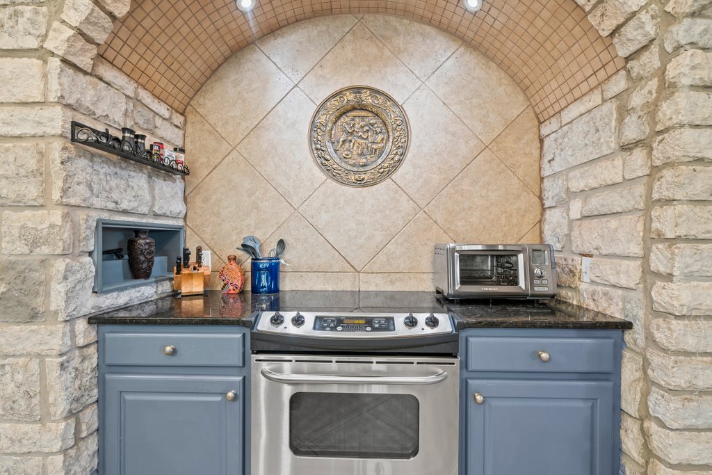 209 Lakeview Circle Spring Branch, TX 78070 - Photo 12 of 40 Kitchen with dark countertops, blue cabinetry, stainless steel electric range oven, and a toaster