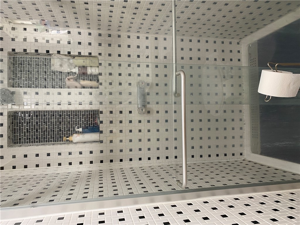 175 Rita Street Dayton, OH 45404 - Photo 38 of 48 This modern shower features elegant tile work and practical recessed shelving for convenience.