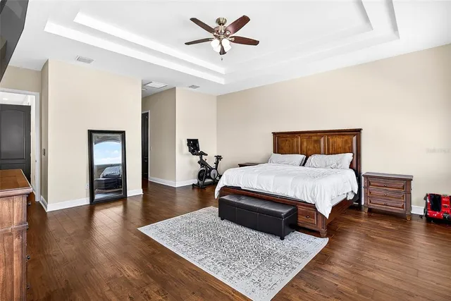a bedroom with a bed rug and wooden floor