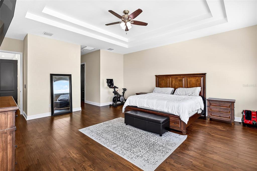 3532 West Shell Point Road Ruskin, FL 33570 - Photo 19 of 40 a bedroom with a bed rug and wooden floor