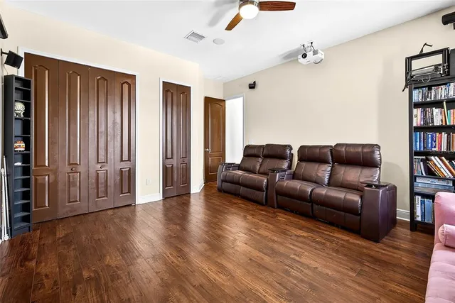 a living room with furniture and a book shelf