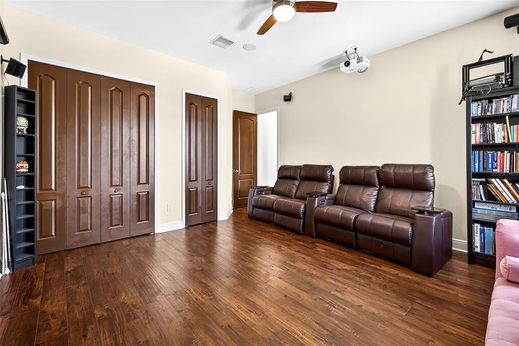 3532 West Shell Point Road Ruskin, FL 33570 - Photo 25 of 40 a living room with furniture and a book shelf