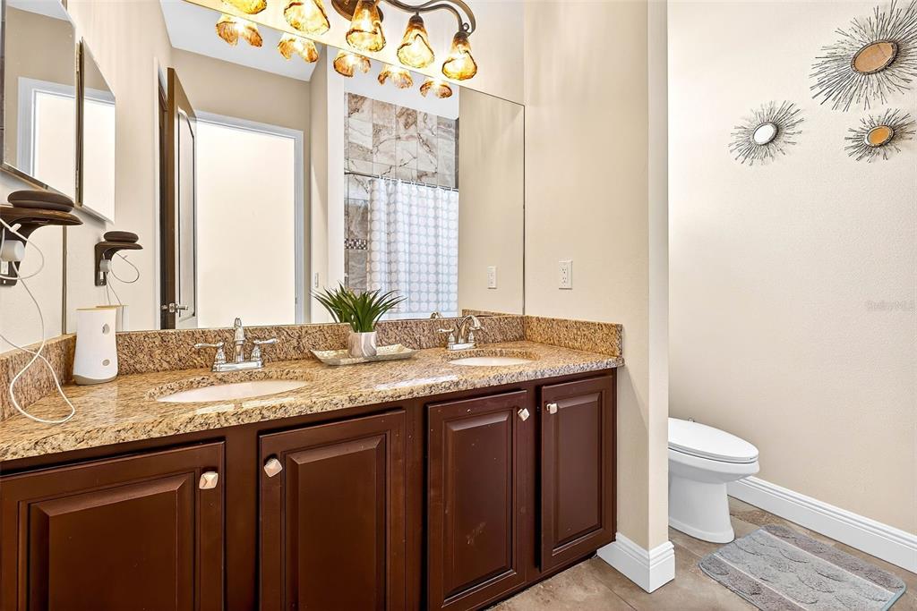 3532 West Shell Point Road Ruskin, FL 33570 - Photo 28 of 40 a bathroom with a granite countertop sink and a toilet