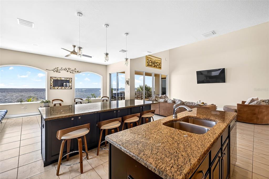 3532 West Shell Point Road Ruskin, FL 33570 - Photo 7 of 40 a kitchen with a table chairs and a refrigerator