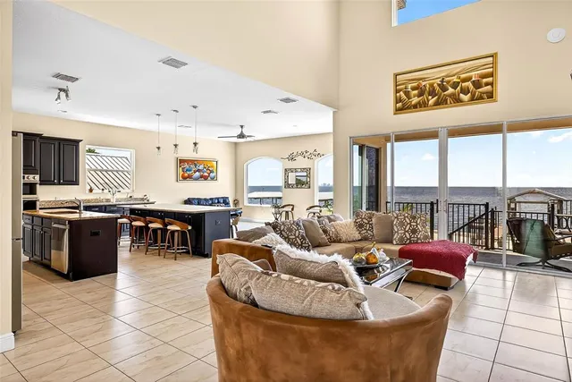 a living room with furniture and kitchen view