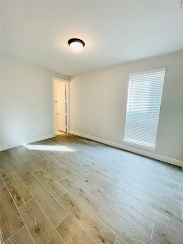 a view of a livingroom with a ceiling fan and window