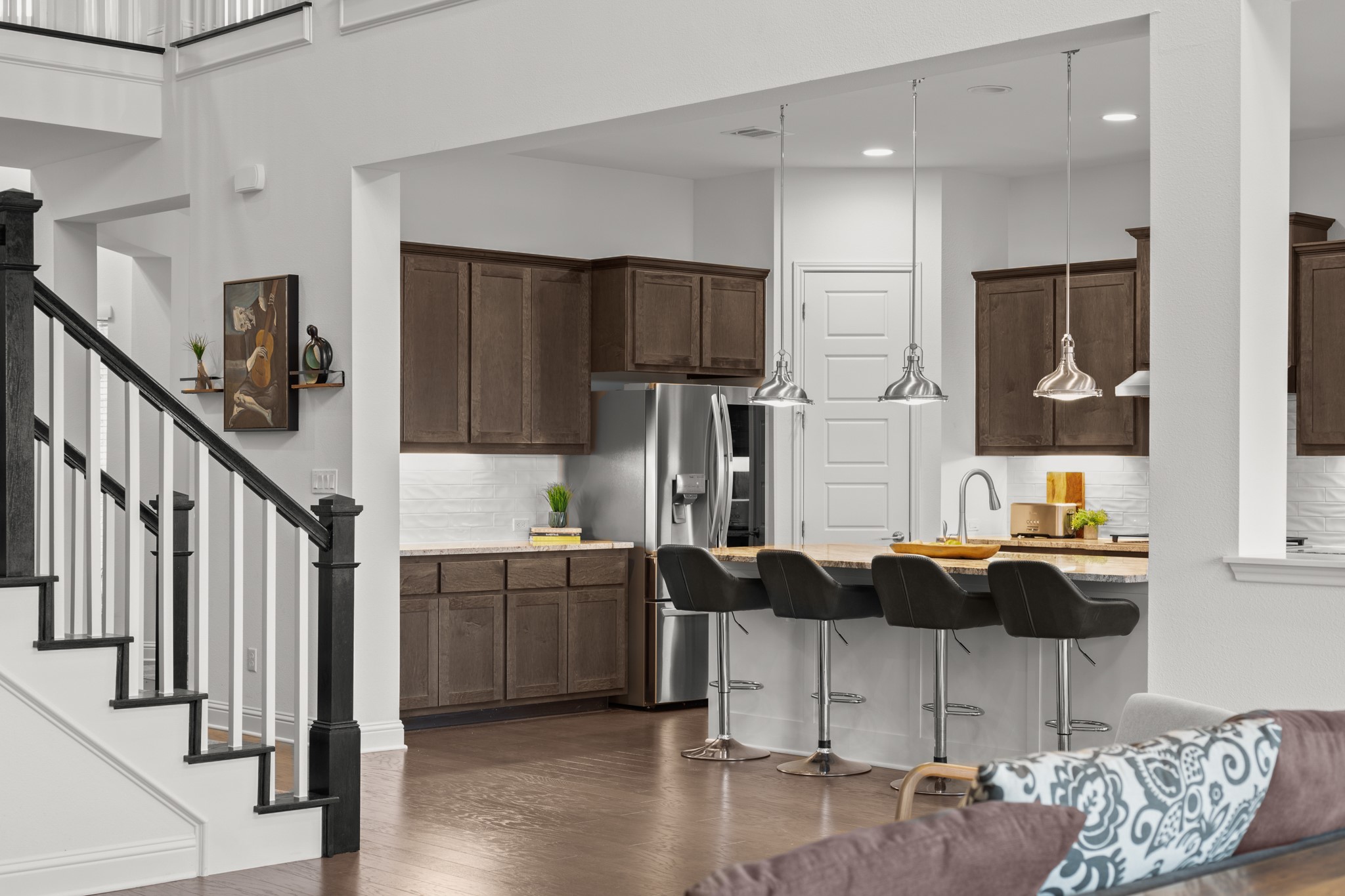 330 Cistern Way Austin, TX 78737 - Photo 11 of 40 a kitchen with stainless steel appliances kitchen island granite countertop a refrigerator and stove