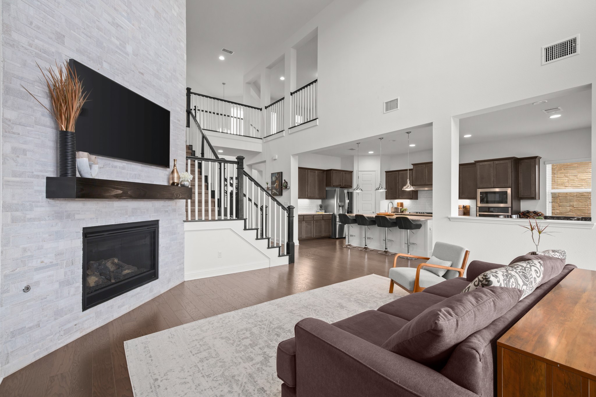 330 Cistern Way Austin, TX 78737 - Photo 13 of 40 a living room with furniture a flat screen tv and a fireplace