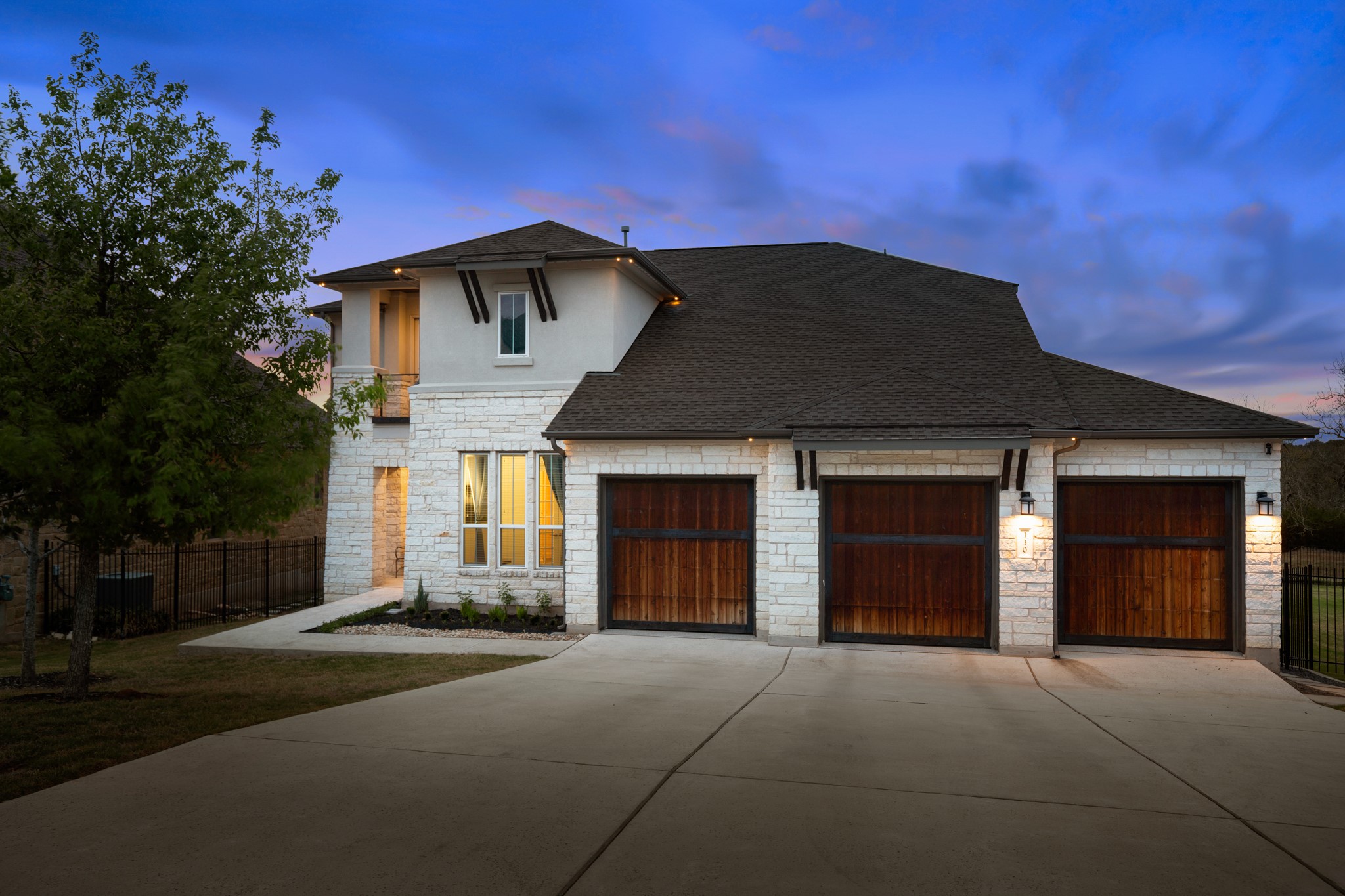 330 Cistern Way Austin, TX 78737 - Photo 2 of 40 a front view of a house with a yard and garage