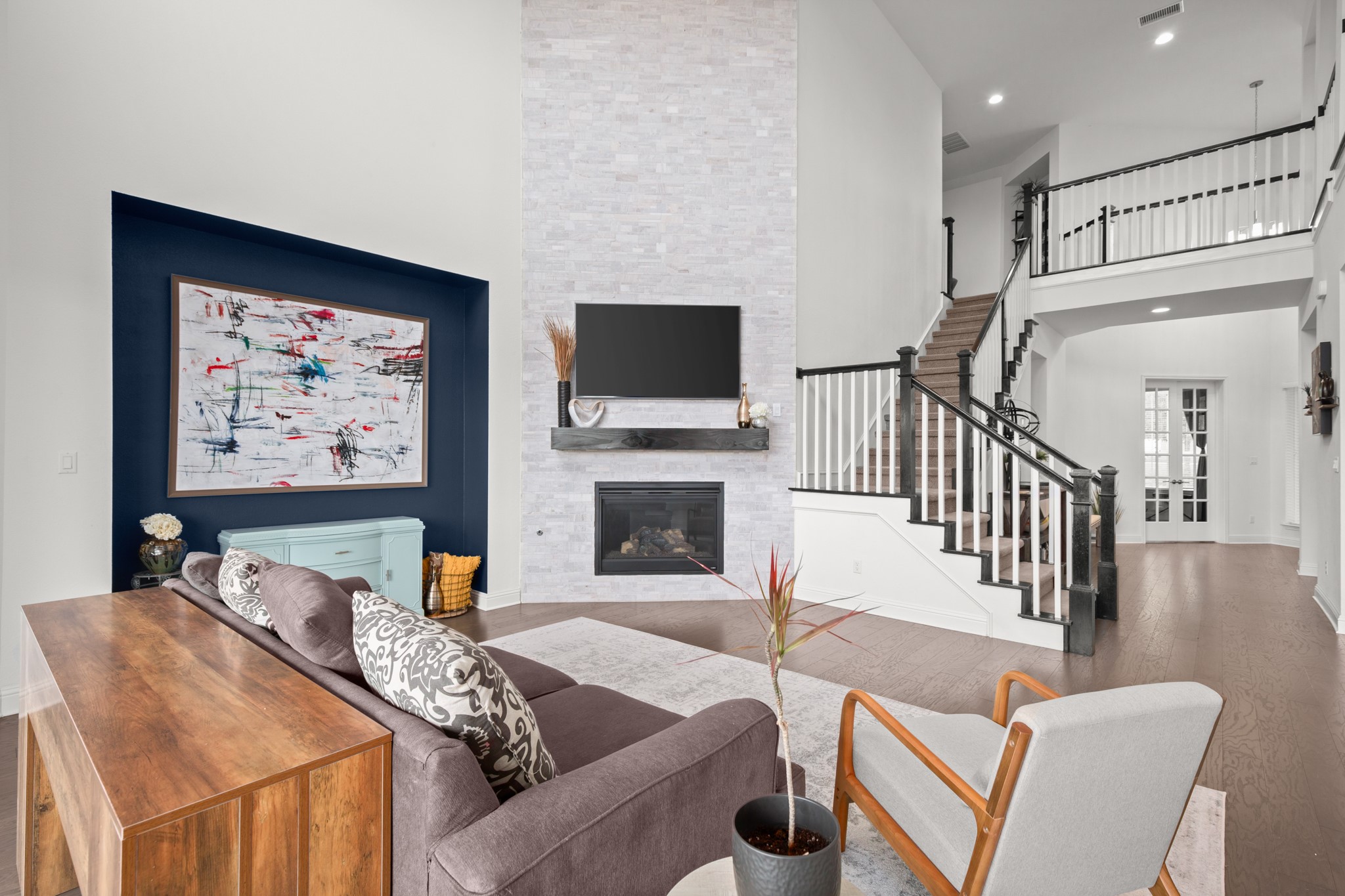 330 Cistern Way Austin, TX 78737 - Photo 24 of 40 a living room with furniture a flat screen tv and a fireplace