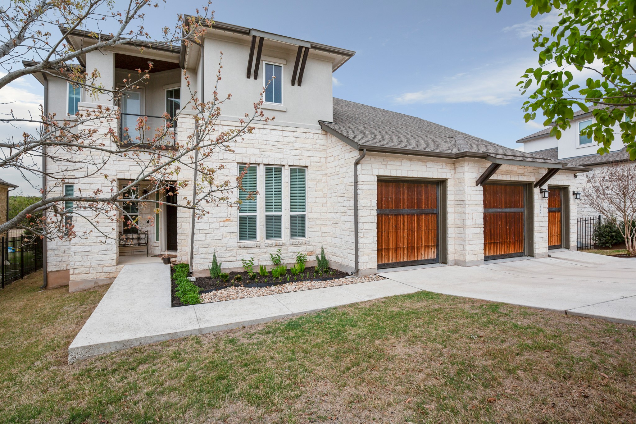 330 Cistern Way Austin, TX 78737 - Photo 39 of 40 a front view of a house with a yard and garage