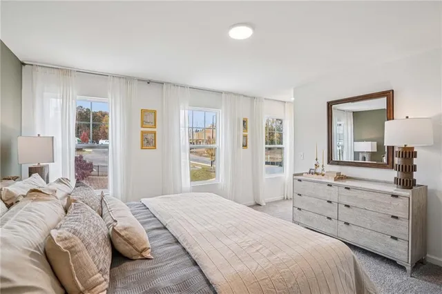a spacious bathroom with a granite countertop double vanity sink a mirror and a shower