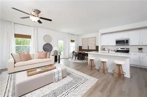 a living room with furniture and kitchen view