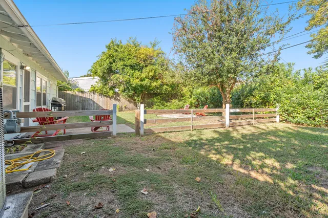 a view of a house with a backyard