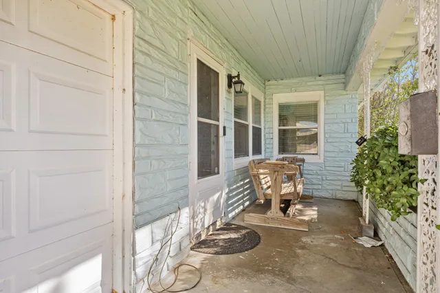 a front view of a house with outdoor seating