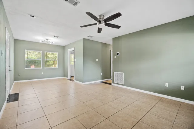 a view of a livingroom with a ceiling fan and window