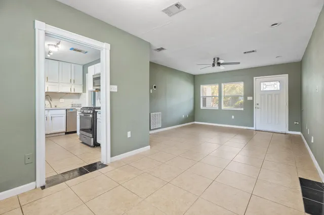 a view of a kitchen with a sink and a refrigerator