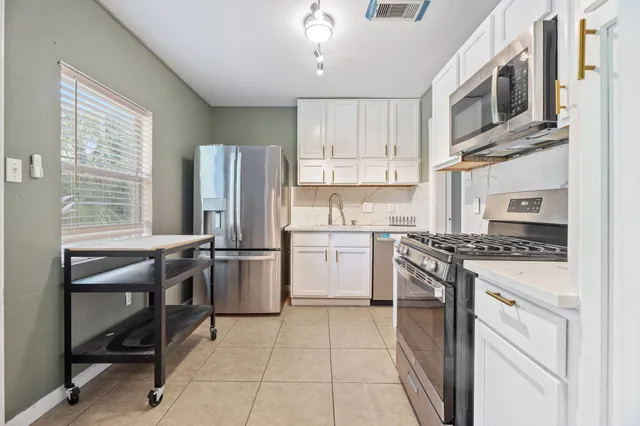 a kitchen with a stove a sink and a refrigerator