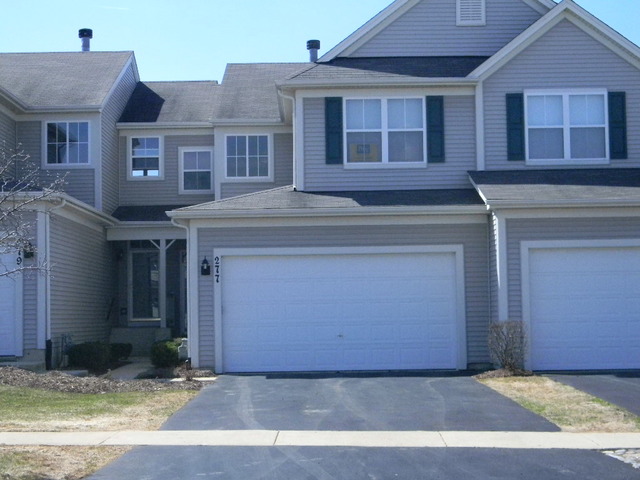 277 Grand Ridge Road, Unit 277 St. Charles, IL 60175 - Photo 1 of 13 a front view of a house with a yard