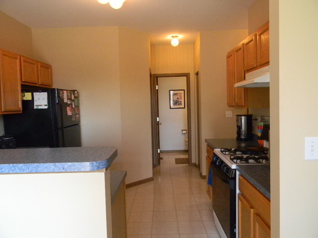 277 Grand Ridge Road, Unit 277 St. Charles, IL 60175 - Photo 6 of 13 a kitchen with stainless steel appliances granite countertop a refrigerator and a stove