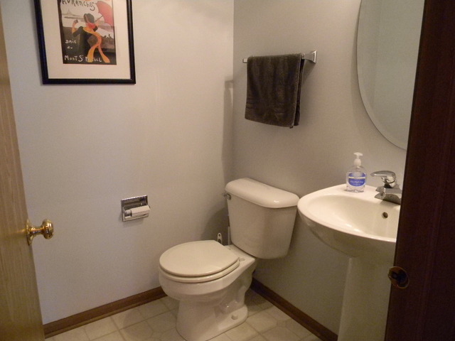 277 Grand Ridge Road, Unit 277 St. Charles, IL 60175 - Photo 8 of 13 a bathroom with a toilet sink and mirror