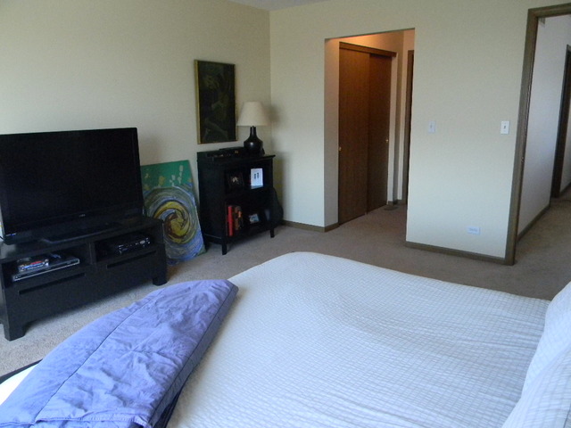 277 Grand Ridge Road, Unit 277 St. Charles, IL 60175 - Photo 9 of 13 a living room with furniture and a flat screen tv