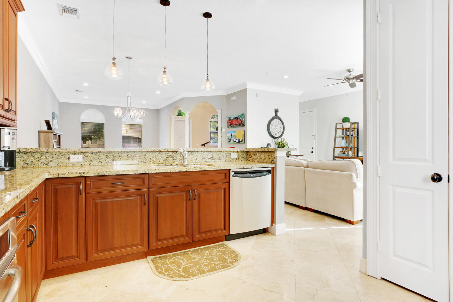 a large kitchen with kitchen island a large counter space a sink stainless steel appliances and cabinets