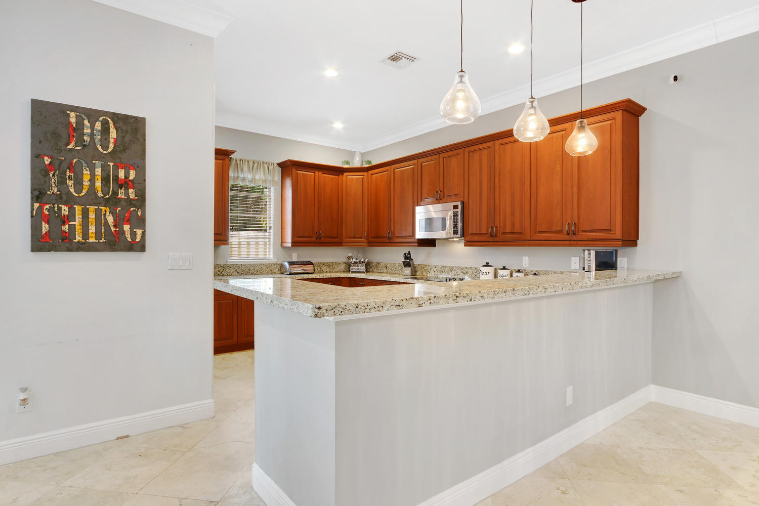 98 Via Poinciana Lane Boca Raton, FL 33487 - Photo 12 of 38 a kitchen with stainless steel appliances granite countertop a sink a stove and a refrigerator